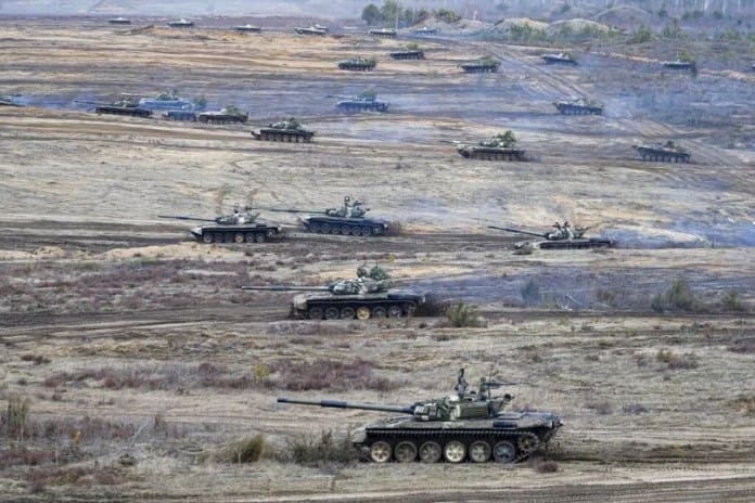 FILE - Tanks move during the Union Courage-2022 Russia-Belarus military drills at the Obuz-Lesnovsky training ground in Belarus, Feb. 19, 2022.