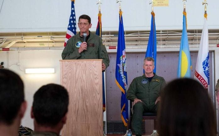 Rear Adm. Gregory Huffman delivers remarks near Adm. Samuel Paparo, head of U.S. Indo-Pacific Command, during the Joint Task Force–Micronesia assumption-of-command ceremony at Anderson Air Force Base, Guam, June 14, 2024.